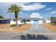 Charming home featuring mature landscaping, palm tree, and a one car garage at 10123 Oak Hill Dr, Port Richey, FL 34668