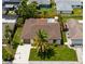 Aerial view of a home showcasing its well-maintained landscaping, private swimming pool, and neighborhood at 10224 Old Orchard Ln, Port Richey, FL 34668