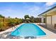 Backyard oasis with a refreshing pool, spacious patio, lounge chairs, and a privacy fence, offering a perfect retreat at 10224 Old Orchard Ln, Port Richey, FL 34668