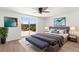 Primary bedroom features a ceiling fan, a sliding glass door to the backyard, and neutral decor at 10224 Old Orchard Ln, Port Richey, FL 34668