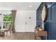 Inviting foyer with a wood accent wall, bright light, and stylish decor, leading to a paneled front door at 10224 Old Orchard Ln, Port Richey, FL 34668