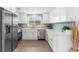 Modern kitchen with stainless steel appliances, white cabinets, quartz counters, and stylish backsplash at 10224 Old Orchard Ln, Port Richey, FL 34668