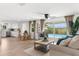 Bright and inviting open floor plan living room with pool views, dining area, and modern decor at 10224 Old Orchard Ln, Port Richey, FL 34668