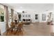 Bright living room with wood-look floors, dining area, comfortable seating, and natural light at 10224 Old Orchard Ln, Port Richey, FL 34668
