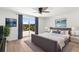 Spacious bedroom features a ceiling fan, a sliding glass door to the backyard, and neutral decor at 10224 Old Orchard Ln, Port Richey, FL 34668