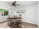 Home office features a ceiling fan, wood flooring, and a desk with shelving at 10224 Old Orchard Ln, Port Richey, FL 34668