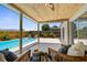 Inviting covered patio with a wood ceiling, seamlessly connecting indoor and outdoor living spaces with a refreshing pool view at 10224 Old Orchard Ln, Port Richey, FL 34668