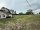 Grassy backyard with partial view of the home, showcasing its outdoor space and potential at 11308 Mahopac Rd, Weeki Wachee, FL 34614