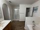 Spacious bathroom with a double vanity, glass-enclosed shower, and a separate toilet area at 11308 Mahopac Rd, Weeki Wachee, FL 34614
