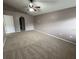 Large bedroom with carpeting, ceiling fan, and an open archway to the rest of the house at 11308 Mahopac Rd, Weeki Wachee, FL 34614