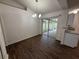 Dining area with laminate flooring and sliding glass doors to the screened porch at 11308 Mahopac Rd, Weeki Wachee, FL 34614