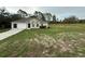 Charming single-story home boasts a two-car garage and a well-maintained front yard with mature trees at 11308 Mahopac Rd, Weeki Wachee, FL 34614