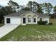 Charming single-story home featuring a manicured lawn, a garage, and a welcoming front entrance at 11308 Mahopac Rd, Weeki Wachee, FL 34614