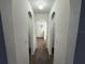 Hallway featuring arched doorways, leading to carpeted rooms on either side at 11308 Mahopac Rd, Weeki Wachee, FL 34614