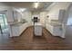 Modern kitchen features white cabinets, granite countertops, and an island at 11308 Mahopac Rd, Weeki Wachee, FL 34614