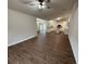 Spacious living area with views of the modern kitchen, featuring hardwood floors and sliding door access at 11308 Mahopac Rd, Weeki Wachee, FL 34614
