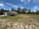 Spacious property featuring a well-maintained lawn, attached garage and generous open land with a house at 11308 Mahopac Rd, Weeki Wachee, FL 34614