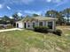 A lovely one-story home with an attached garage, lush green lawn, and a well-kept landscaped front yard at 11308 Mahopac Rd, Weeki Wachee, FL 34614