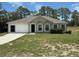 Charming single-story home with an attached garage, fresh lawn, and a neatly landscaped front yard at 11308 Mahopac Rd, Weeki Wachee, FL 34614