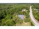 Scenic aerial view of home with lush greenery and neighborhood street access at 11510 Lakeview Dr, New Port Richey, FL 34654