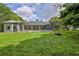 Expansive backyard with a screened-in pool and lush green lawn at 11510 Lakeview Dr, New Port Richey, FL 34654