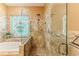 Elegant bathroom featuring a glass-enclosed shower and stained glass window at 11510 Lakeview Dr, New Port Richey, FL 34654