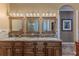 Spacious bathroom with double vanities, granite countertops, and wooden cabinetry at 11510 Lakeview Dr, New Port Richey, FL 34654