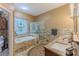 Beautiful bathroom with soaking tub, glass enclosed shower, and double sinks at 11510 Lakeview Dr, New Port Richey, FL 34654