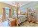 Comfortable bedroom with a four-poster bed and tiled floors at 11510 Lakeview Dr, New Port Richey, FL 34654
