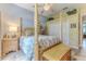 Charming bedroom with a four poster bed and tiled floors at 11510 Lakeview Dr, New Port Richey, FL 34654
