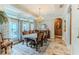 The well-lit dining room showcases a stylish chandelier, large windows, and decorative rug, enhancing the home's appeal at 11510 Lakeview Dr, New Port Richey, FL 34654