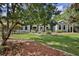 Inviting home with a landscaped front yard, mature trees, and charming fountain at 11510 Lakeview Dr, New Port Richey, FL 34654