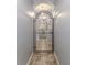 Hallway with tiled flooring and a decorative wrought iron gate adds an architectural flair at 11510 Lakeview Dr, New Port Richey, FL 34654