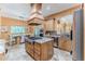 Modern kitchen features stainless steel appliances, a granite island with a gas cooktop, and custom cabinetry at 11510 Lakeview Dr, New Port Richey, FL 34654