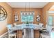 Kitchen island features granite countertops, seating, and stylish pendant lighting, ideal for casual dining at 11510 Lakeview Dr, New Port Richey, FL 34654