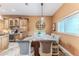 Kitchen island offers a breakfast bar with seating, pendant lighting, and views of the surrounding kitchen area at 11510 Lakeview Dr, New Port Richey, FL 34654