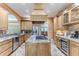 Gourmet kitchen boasts stainless steel appliances, granite countertops, and a center island with a gas cooktop at 11510 Lakeview Dr, New Port Richey, FL 34654