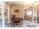 Open living space featuring a piano and arched doorway to the dining area at 11510 Lakeview Dr, New Port Richey, FL 34654