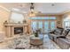 Cozy living room with a stone fireplace and view of the outdoor pool at 11510 Lakeview Dr, New Port Richey, FL 34654