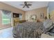 Comfortable main bedroom featuring a ceiling fan and a large window providing natural light at 11510 Lakeview Dr, New Port Richey, FL 34654