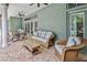 Covered outdoor patio with ceiling fans, wicker furniture, and lush garden view at 11510 Lakeview Dr, New Port Richey, FL 34654