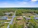 An aerial view showcases the layout of the residence, complete with a fenced backyard, patio and its neighborhood surroundings at 12026 Penguin Ave, Weeki Wachee, FL 34614