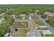 Drone shot displays this charming home, the fenced yard with fire pit, and the serene neighborhood location at 12026 Penguin Ave, Weeki Wachee, FL 34614