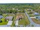 Aerial showcases the property, its well-maintained lawn, and the privacy offered by the surrounding white picket fence at 12026 Penguin Ave, Weeki Wachee, FL 34614
