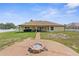 Outdoor living enhanced by a covered patio and inviting fire pit in a spacious backyard setting at 12026 Penguin Ave, Weeki Wachee, FL 34614