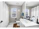 Bathroom with a white vanity and shower with white curtains at 12026 Penguin Ave, Weeki Wachee, FL 34614