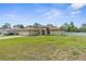 Spacious single-story home featuring a sprawling green lawn and well-maintained landscaping at 12026 Penguin Ave, Weeki Wachee, FL 34614