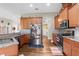 Spacious kitchen with stainless steel appliances, wooden cabinets, and hardwood flooring at 12026 Penguin Ave, Weeki Wachee, FL 34614