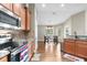 Well-lit kitchen featuring hardwood floors, stainless steel appliances, and an adjacent dining area at 12026 Penguin Ave, Weeki Wachee, FL 34614