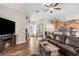 Bright and airy living room with hardwood floors, an open layout, and stylish furnishings at 12026 Penguin Ave, Weeki Wachee, FL 34614
